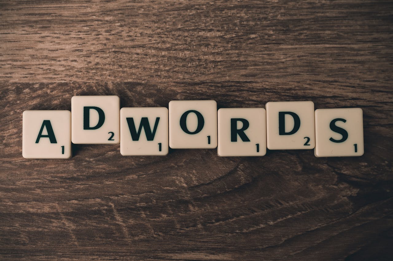 hero-img Scrabble tiles spelling 'AdWords' on a wooden surface, symbolizing digital marketing concepts.