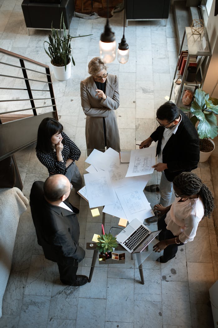 experience-img A team of professionals engage in a business meeting in a sleek, modern office setting.