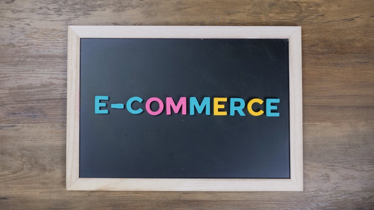 about-me-01 Colorful letters spelling 'e-commerce' on a wooden framed blackboard.