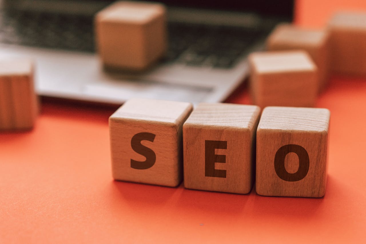 our-journey-03 Wooden blocks spelling SEO on a laptop keyboard convey digital marketing concepts.